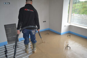 ADM Floor Screed Worker Pouring Liquid Screed