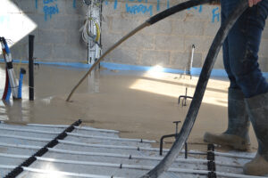 ADM Floor Screed Worker Pouring Liquid Screed